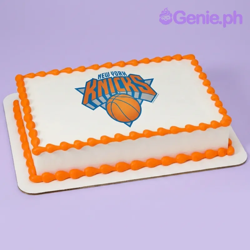A white and orange Rectangle cake themed around New York Knicks, featuring a New York Knicks basketball logo printout and orange piped icing borders. A white and orange Rectangle cake themed around New York Knicks, featuring a New York Knicks basketball logo printout and orange piped icing borders.