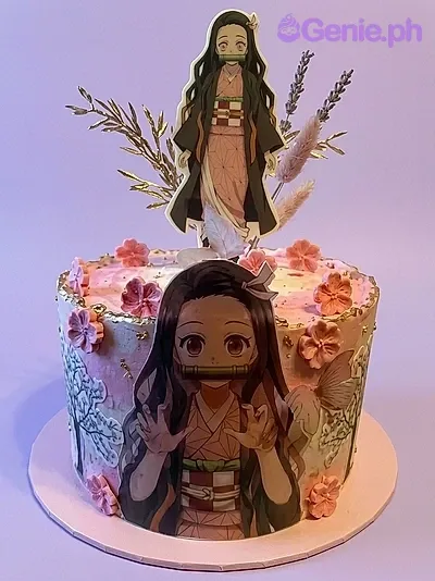 A pink 1 Tier cake featuring a Nezuko character print and edible pink cherry blossom and gold leaf decorations. A pink 1 Tier cake featuring a Nezuko character print and edible pink cherry blossom and gold leaf decorations.
