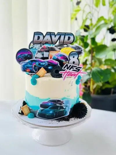 Sky blue and white 1-tier soft icing cake with NFS Racing Car printouts, a name topper, and Oreo cookies Sky blue and white 1-tier soft icing cake with NFS Racing Car printouts, a name topper, and Oreo cookies