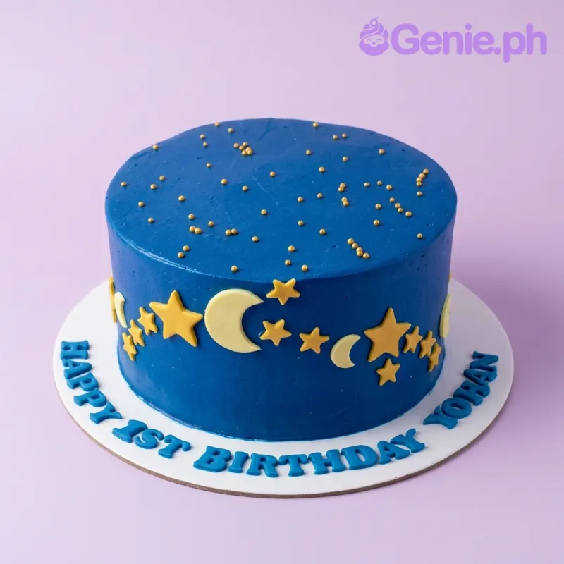 Blue night sky themed birthday cake with yellow fondant stars and crescent moons and gold sprinkles. Blue night sky themed birthday cake with yellow fondant stars and crescent moons and gold sprinkles.