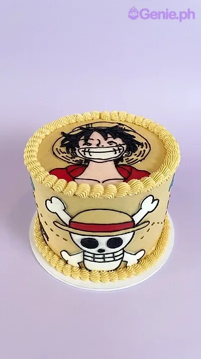 A tan and yellow 1 Tier cake themed around One Piece Luffy, featuring a Monkey D. Luffy portrait and Straw Hat Jolly Roger, with yellow piped borders. A tan and yellow 1 Tier cake themed around One Piece Luffy, featuring a Monkey D. Luffy portrait and Straw Hat Jolly Roger, with yellow piped borders.