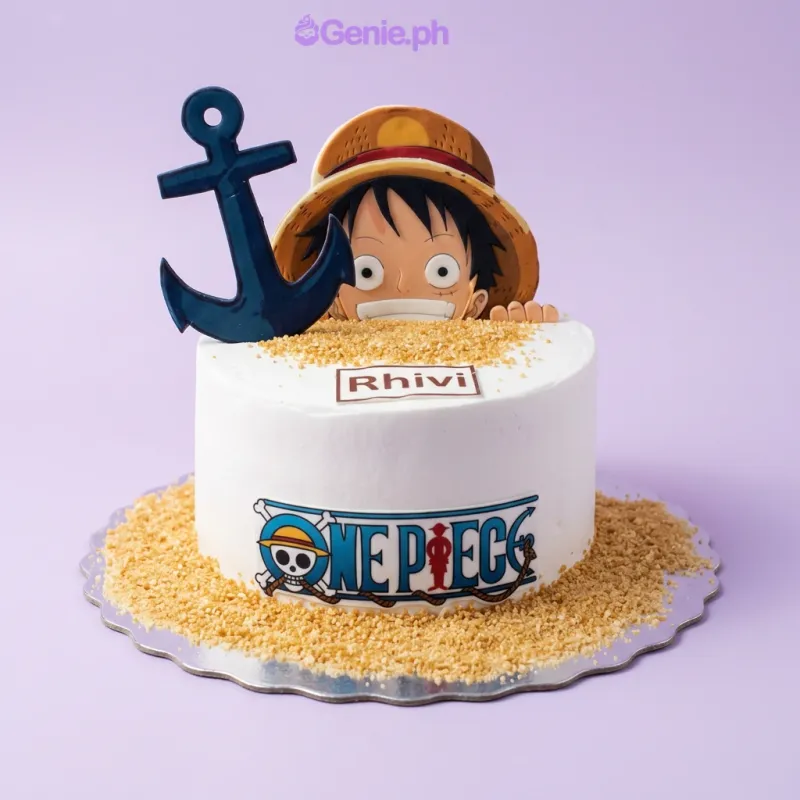 A blue 1 Tier Fondant cake themed around One Piece, featuring a Luffy topper, straw hat, anchor, ship wheel, and personalized text. A blue 1 Tier Fondant cake themed around One Piece, featuring a Luffy topper, straw hat, anchor, ship wheel, and personalized text.