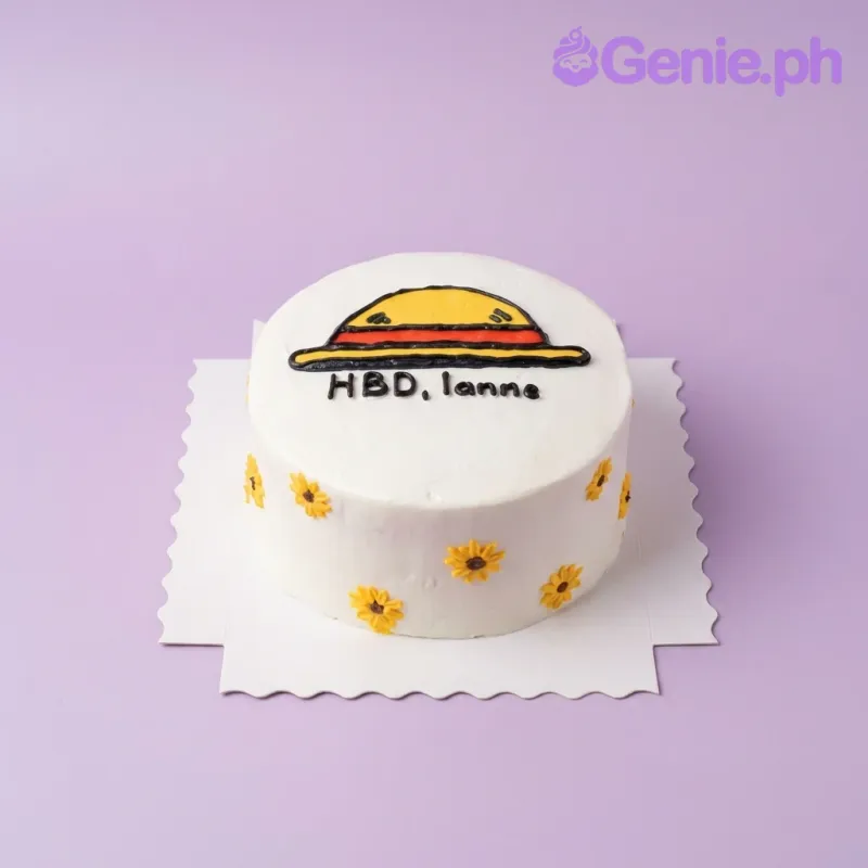 A white 1 Tier cake themed around One Piece Straw Hat, featuring a hand-piped yellow straw hat and yellow floral accents. A white 1 Tier cake themed around One Piece Straw Hat, featuring a hand-piped yellow straw hat and yellow floral accents.