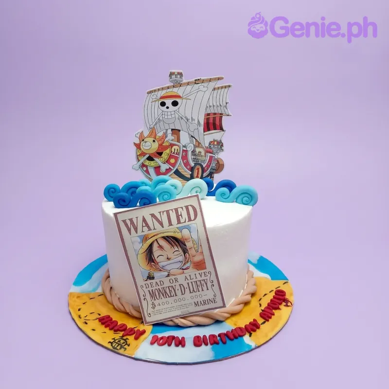 A white, blue, yellow 1-tier cake, One Piece themed, with a Thousand Sunny ship, Luffy wanted poster, and blue waves. A white, blue, yellow 1-tier cake, One Piece themed, with a Thousand Sunny ship, Luffy wanted poster, and blue waves.