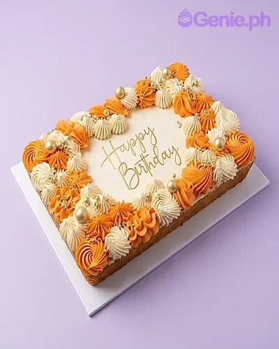 A rectangle cake featuring orange and white icing swirls, gold sprinkles, and a 'Happy Birthday' message. A rectangle cake featuring orange and white icing swirls, gold sprinkles, and a 'Happy Birthday' message.
