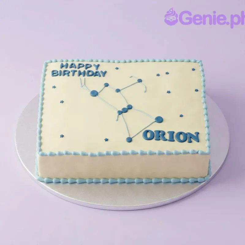 A yellow rectangular cake with a blue Orion Constellation design, blue icing borders, and blue text. A yellow rectangular cake with a blue Orion Constellation design, blue icing borders, and blue text.