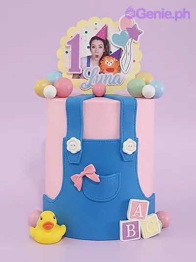 Pink fondant cake with blue overall design, yellow rubber duck, and a personalized photo topper for Luna's 1st birthday. Pink fondant cake with blue overall design, yellow rubber duck, and a personalized photo topper for Luna's 1st birthday.