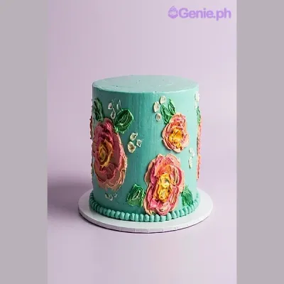 Teal 1-tier cake with painted pink and yellow rose flowers and a piped border Teal 1-tier cake with painted pink and yellow rose flowers and a piped border