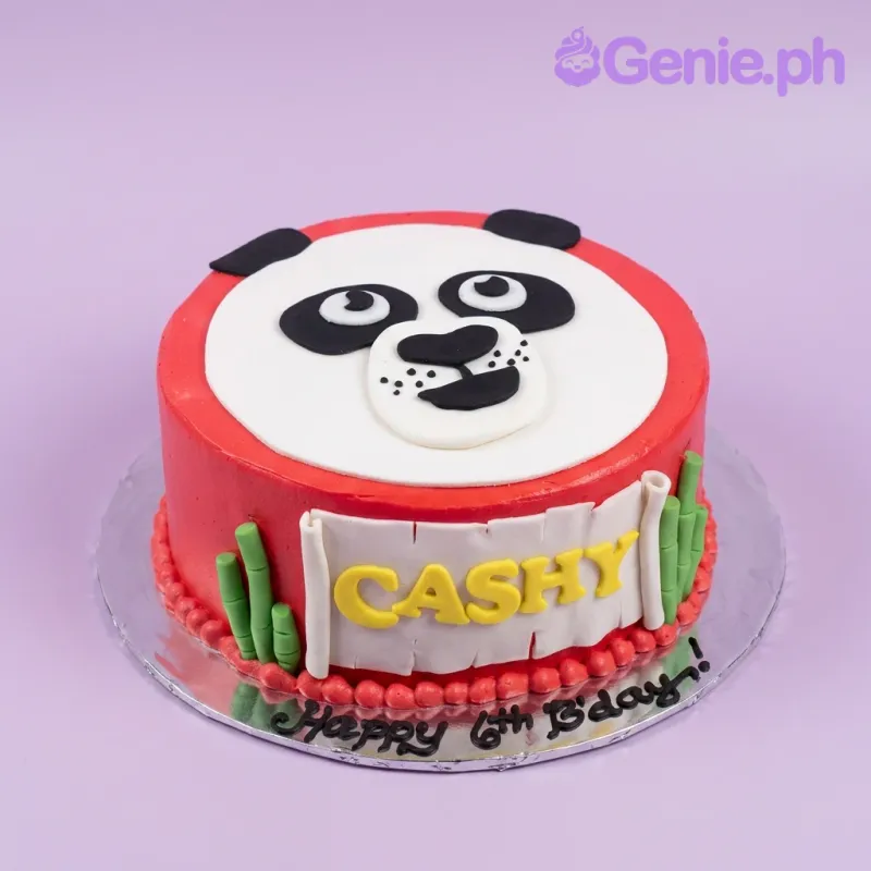 A red and white 1-tier cake themed around Panda, featuring a panda face, green bamboo accents, a yellow name banner, and a red beaded border. A red and white 1-tier cake themed around Panda, featuring a panda face, green bamboo accents, a yellow name banner, and a red beaded border.