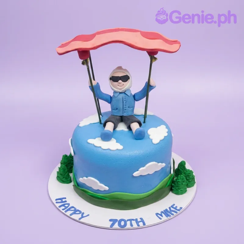 A blue, green, and white 1 Tier Fondant cake themed around Paragliding, featuring a 3D paraglider, clouds, and hills. A blue, green, and white 1 Tier Fondant cake themed around Paragliding, featuring a 3D paraglider, clouds, and hills.