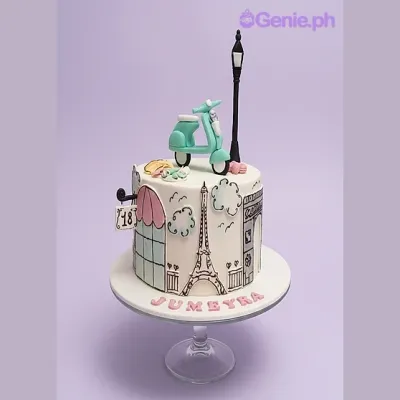White 1-tier fondant cake with a blue scooter and lamp post topper featuring hand-painted Parisian landmarks on the side White 1-tier fondant cake with a blue scooter and lamp post topper featuring hand-painted Parisian landmarks on the side