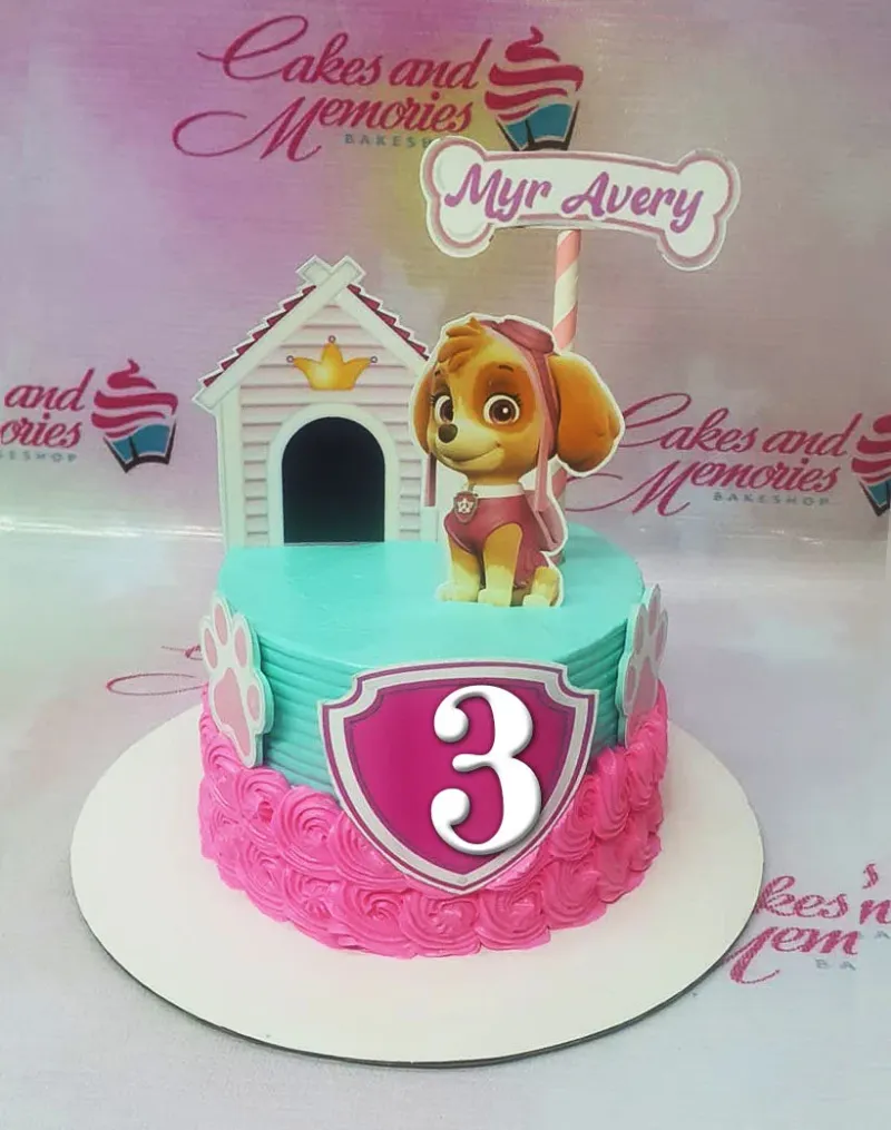 A teal and pink 1-tier cake themed Paw Patrol Skye, featuring Skye, a dog house, and a pink number 3 shield. A teal and pink 1-tier cake themed Paw Patrol Skye, featuring Skye, a dog house, and a pink number 3 shield.