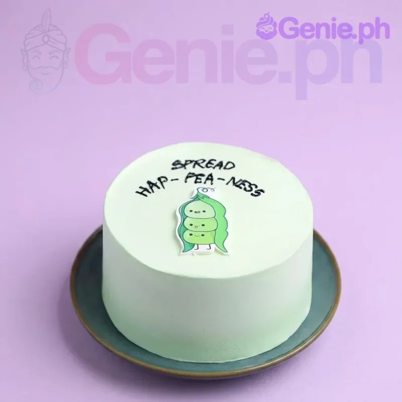 A light green 1 Tier cake themed around Pea Pod Bento, featuring a printout of three peas in a pod and 'SPREAD HAP-PEA-NESS' in black icing. A light green 1 Tier cake themed around Pea Pod Bento, featuring a printout of three peas in a pod and 'SPREAD HAP-PEA-NESS' in black icing.