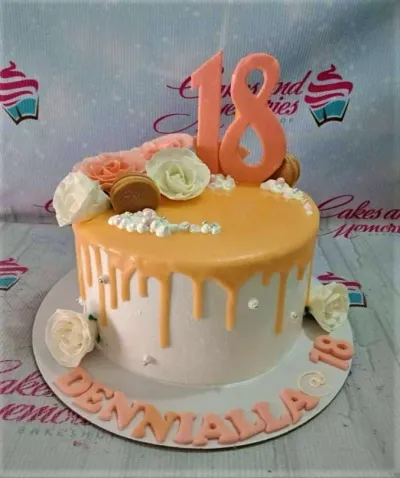 A white 1-tier Peach 18th Birthday cake with orange drip, peach 18 topper, peach roses, and gold macarons. A white 1-tier Peach 18th Birthday cake with orange drip, peach 18 topper, peach roses, and gold macarons.