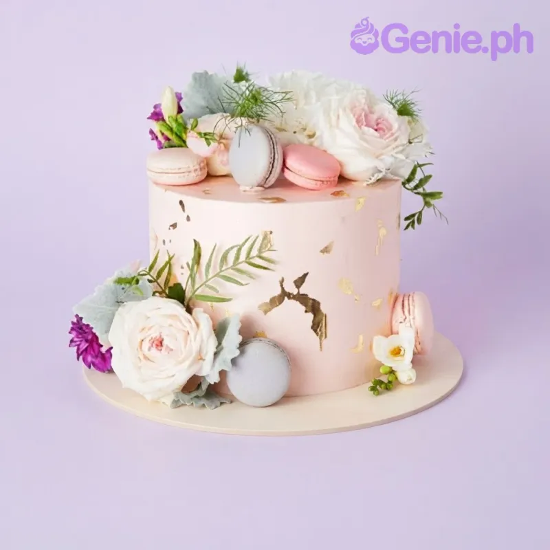 Peach 1-tier cake with soft icing, gold leaf flakes, pastel macarons, and white floral arrangements Peach 1-tier cake with soft icing, gold leaf flakes, pastel macarons, and white floral arrangements