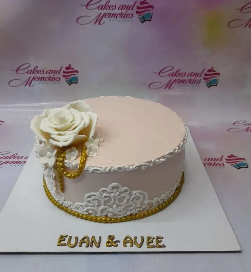 A peach 1-tier cake themed Peach Rose, with a large white gumpaste rose, gold pearl accents, and white icing filigree. A peach 1-tier cake themed Peach Rose, with a large white gumpaste rose, gold pearl accents, and white icing filigree.