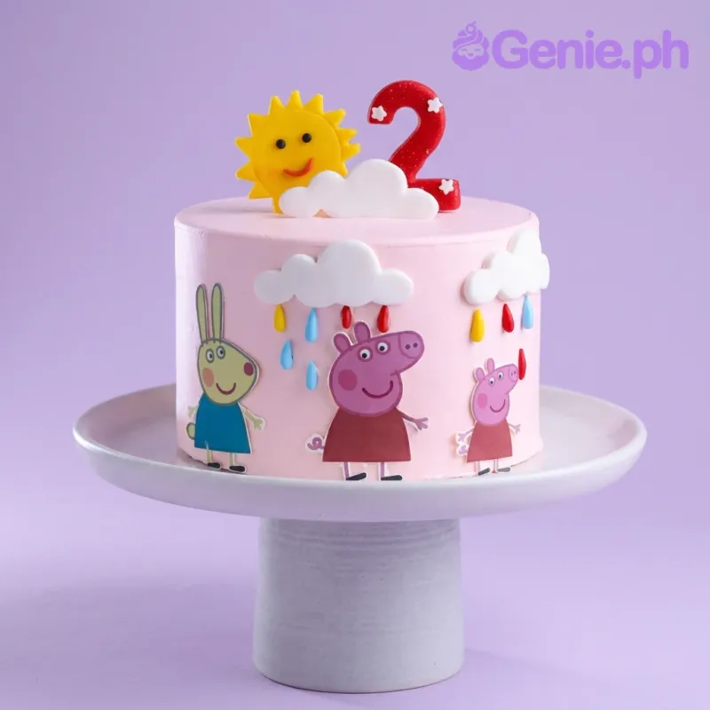 Pink Peppa Pig themed birthday cake with fondant sun, clouds, and character cutouts on a white cake stand. Pink Peppa Pig themed birthday cake with fondant sun, clouds, and character cutouts on a white cake stand.