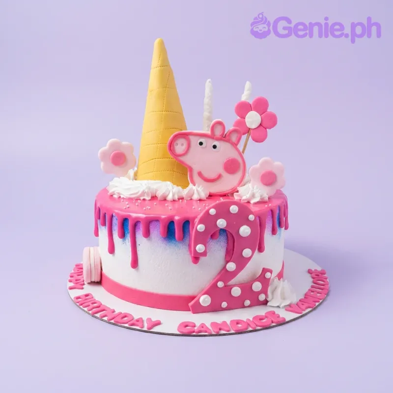 A pink and white 1-tier Peppa Pig cake, with Peppa Pig, a pink number two, yellow cone, and pink drip. A pink and white 1-tier Peppa Pig cake, with Peppa Pig, a pink number two, yellow cone, and pink drip.