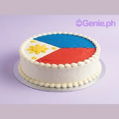 Round white cake with a Philippine flag design on top featuring blue, red, and yellow icing details Round white cake with a Philippine flag design on top featuring blue, red, and yellow icing details
