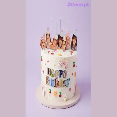 White 1-tier birthday Memory Cake with photo cutouts of children in party hats, colorful piped icing hearts, and a Happy Birthday printout White 1-tier birthday Memory Cake with photo cutouts of children in party hats, colorful piped icing hearts, and a Happy Birthday printout