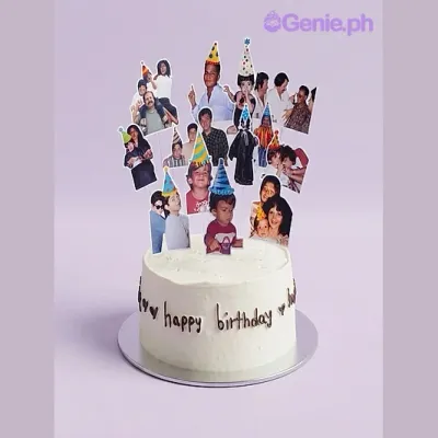 White 1-tier Memory cake with smooth soft icing, black piped birthday message, and numerous photo cutouts of people wearing party hats White 1-tier Memory cake with smooth soft icing, black piped birthday message, and numerous photo cutouts of people wearing party hats