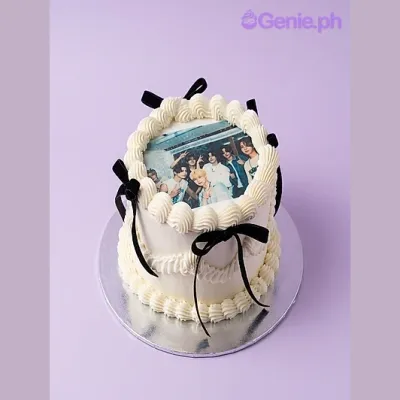 One tier white cake with a rectangular photo print and black ribbon One tier white cake with a rectangular photo print and black ribbon
