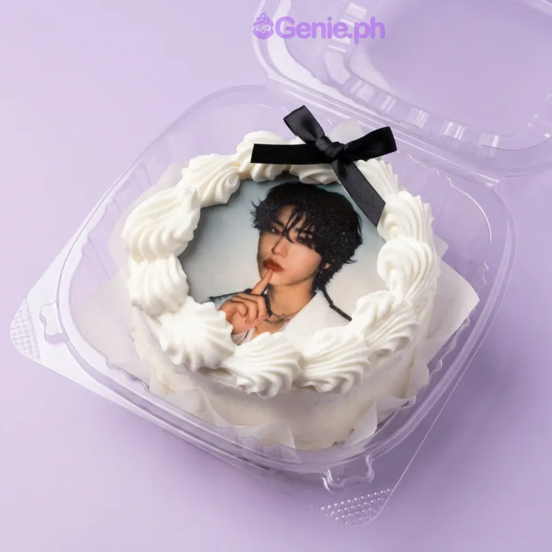 White bento cake with a photo print of a person, a black ribbon bow, and white icing rosettes White bento cake with a photo print of a person, a black ribbon bow, and white icing rosettes