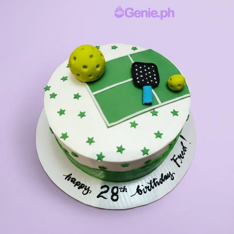 White 1-tier birthday cake with green pickleball court topper and pickleball paddle and balls White 1-tier birthday cake with green pickleball court topper and pickleball paddle and balls
