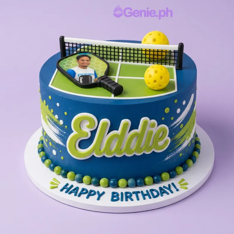 Navy blue fondant cake with a pickleball court printout, net, and pickleballs on top, featuring a name cutout and birthday message. Navy blue fondant cake with a pickleball court printout, net, and pickleballs on top, featuring a name cutout and birthday message.