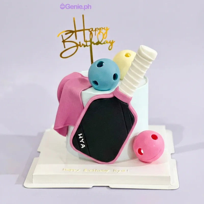 Light blue 1-tier cake with a pickleball paddle topper, gold Happy Birthday sign, and fondant pickleballs. Light blue 1-tier cake with a pickleball paddle topper, gold Happy Birthday sign, and fondant pickleballs.