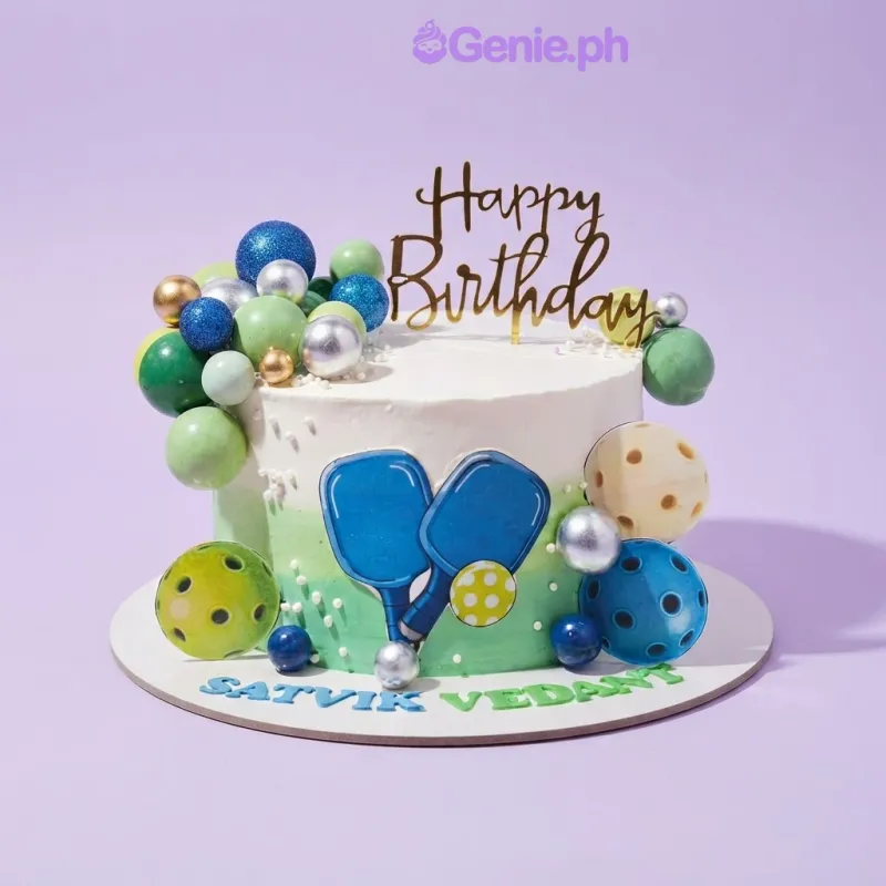 White and light green gradient cake with pickleball paddle printout, assorted decorative spheres, and a gold Happy Birthday topper White and light green gradient cake with pickleball paddle printout, assorted decorative spheres, and a gold Happy Birthday topper
