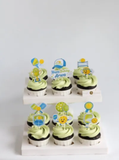 Light green icing cupcakes with pickleball theme printout toppers and birthday message Light green icing cupcakes with pickleball theme printout toppers and birthday message