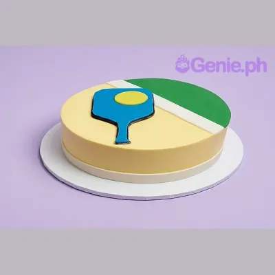 Yellow single tier cake with a blue pickleball paddle and yellow ball design on top Yellow single tier cake with a blue pickleball paddle and yellow ball design on top
