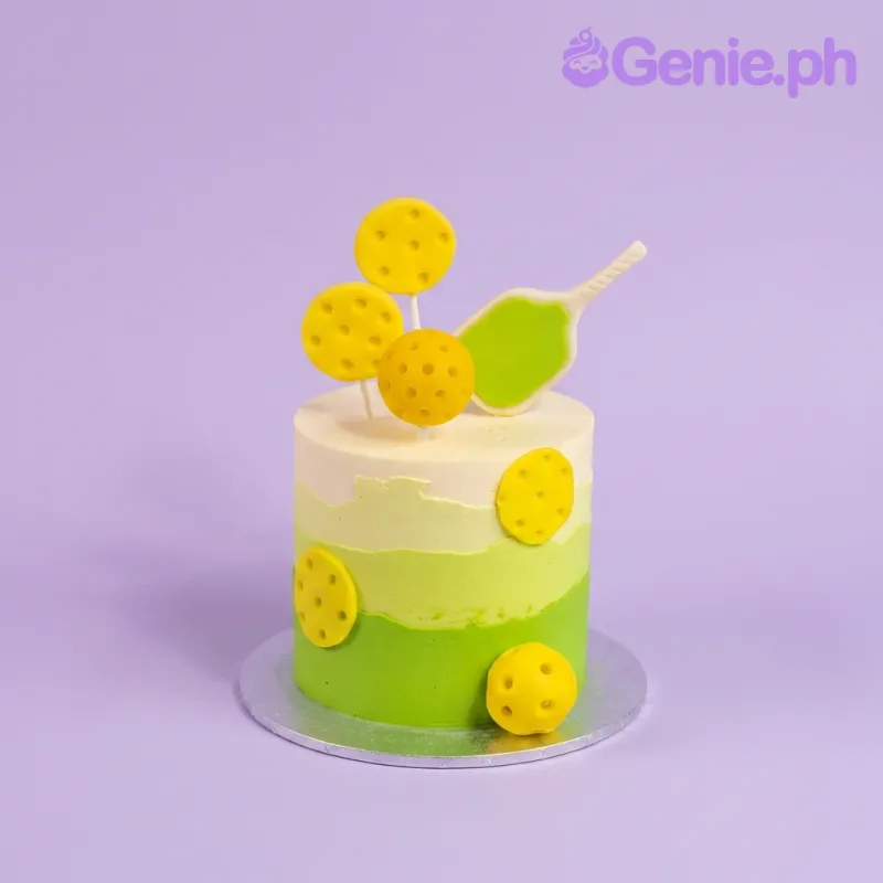 Green and yellow gradient single tier cake with yellow pickleball toppers and paddles Green and yellow gradient single tier cake with yellow pickleball toppers and paddles