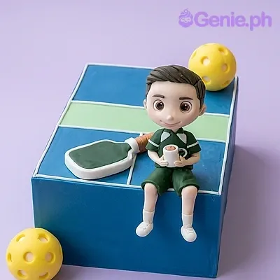 Blue square fondant cake with a pickleball court design featuring a fondant boy figure and pickleball paddle Blue square fondant cake with a pickleball court design featuring a fondant boy figure and pickleball paddle