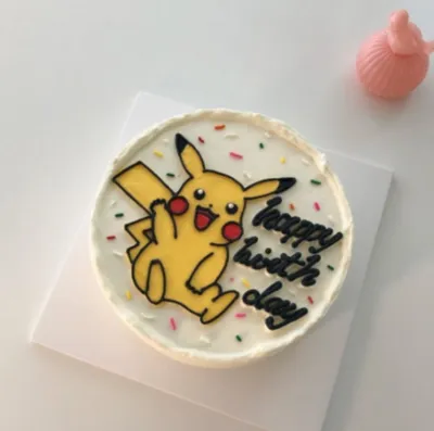 White 1-tier cake with smooth soft icing, a Pikachu character topper, and colorful sprinkles White 1-tier cake with smooth soft icing, a Pikachu character topper, and colorful sprinkles