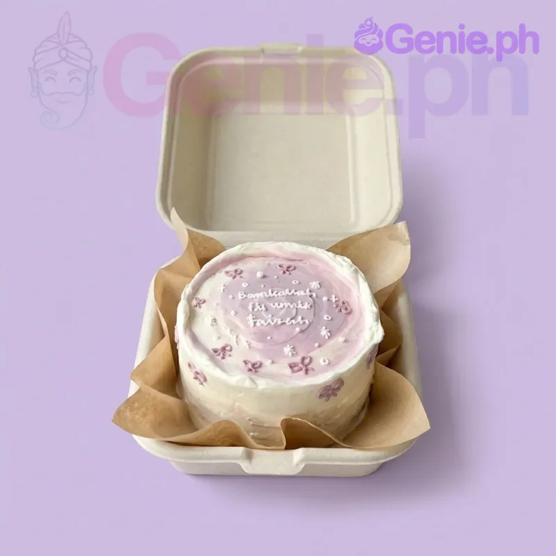 A pink and white Bento cake with a textured finish, featuring pink icing bows, white icing stars, and white text. A pink and white Bento cake with a textured finish, featuring pink icing bows, white icing stars, and white text.