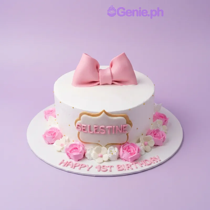 A white and pink 1-tier cake themed Pink Bow Birthday, featuring a large pink fondant bow, pink icing roses, and a personalized name plaque. A white and pink 1-tier cake themed Pink Bow Birthday, featuring a large pink fondant bow, pink icing roses, and a personalized name plaque.
