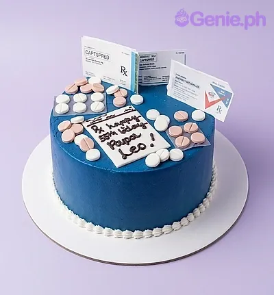 A blue 1 Tier Fondant cake themed around medical pills, featuring pill box printouts, edible round pills, and blister packs. A blue 1 Tier Fondant cake themed around medical pills, featuring pill box printouts, edible round pills, and blister packs.