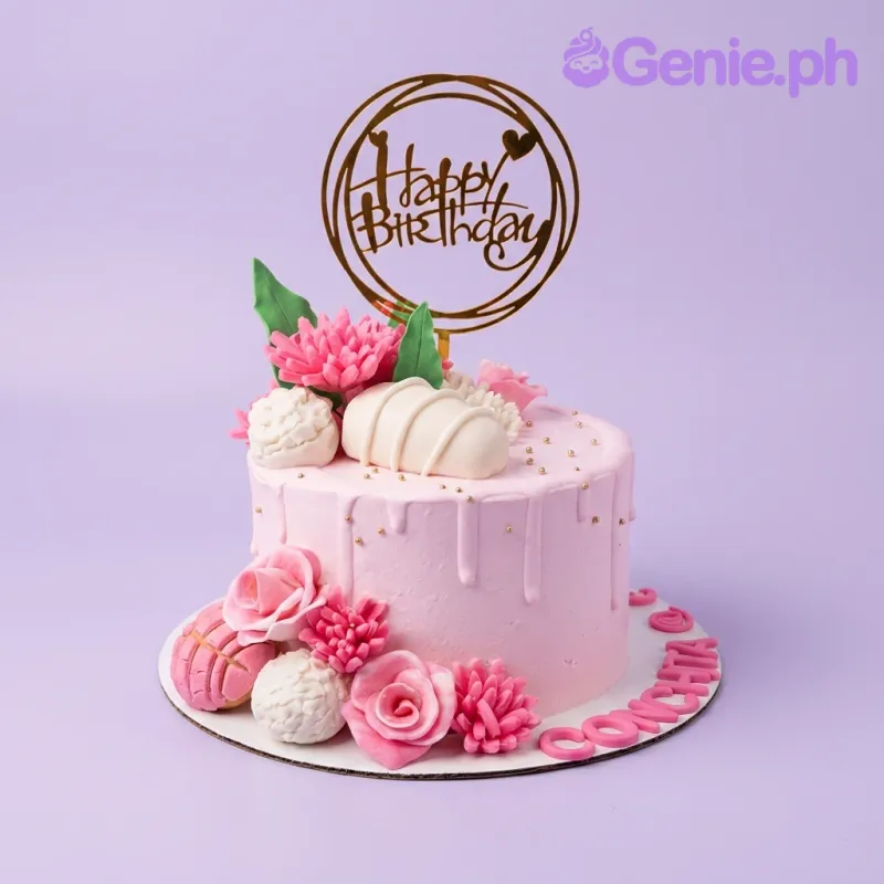 Pink single tier cake with pink and white edible flowers, a gold Happy Birthday topper, and pink gumpaste letters spelling Conchita. Pink single tier cake with pink and white edible flowers, a gold Happy Birthday topper, and pink gumpaste letters spelling Conchita.