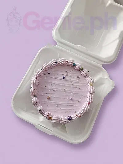 A soft pink Bento cake themed around Pink Minimalist, featuring a piped icing border and colorful sprinkles with metallic beads. A soft pink Bento cake themed around Pink Minimalist, featuring a piped icing border and colorful sprinkles with metallic beads.