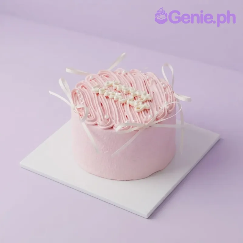 Pink 1-tier soft icing cake with piped vertical lines, white ribbon bows, and sugar pearls Pink 1-tier soft icing cake with piped vertical lines, white ribbon bows, and sugar pearls
