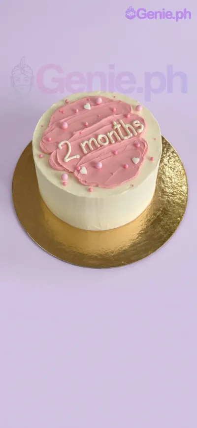 Minimalist white bento cake with a pink palette knife icing smear on top and white piped message reading 2 months. Minimalist white bento cake with a pink palette knife icing smear on top and white piped message reading 2 months.