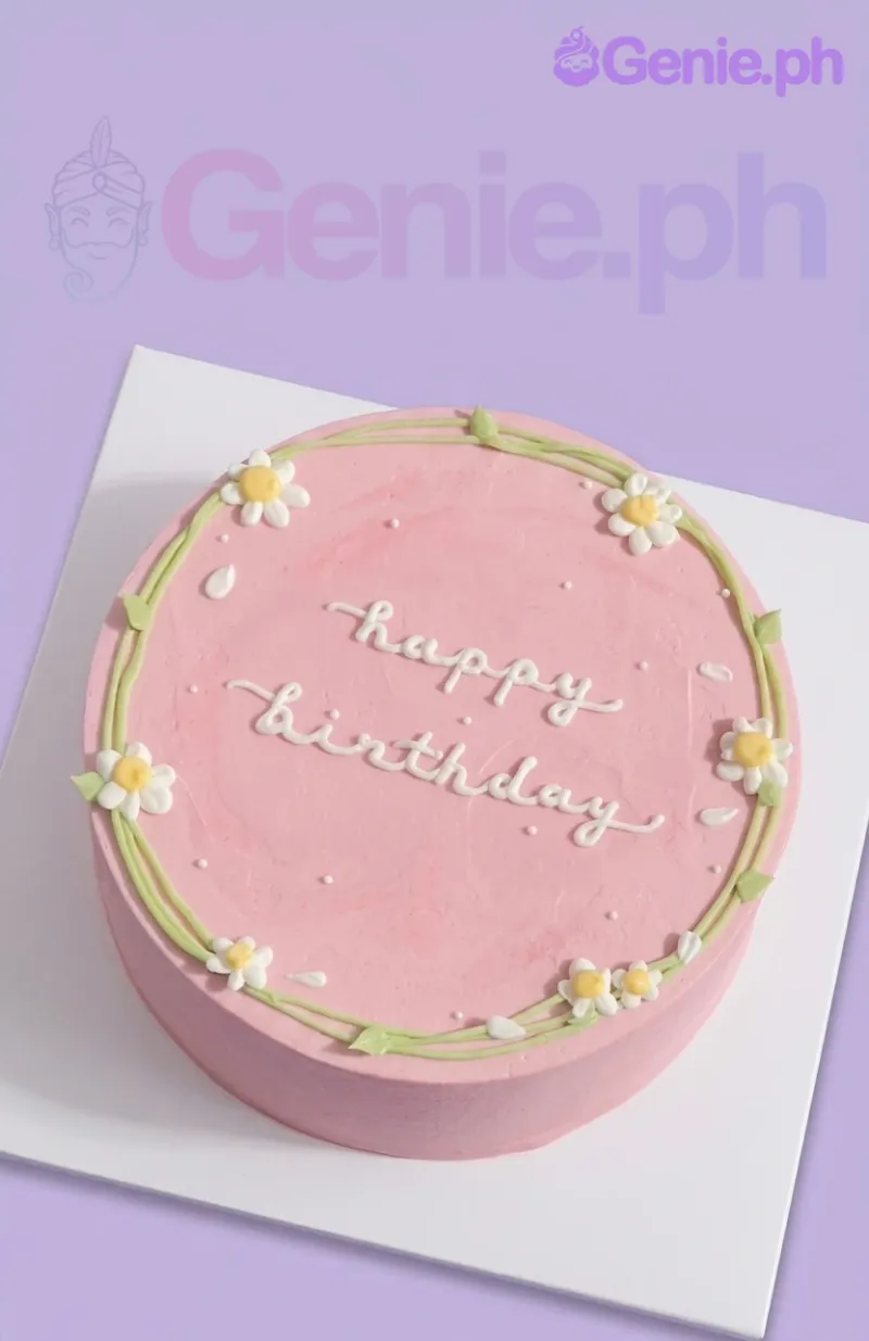 A pink and white 1-tier cake themed around Pink Minimalist, with piped white daisies, a green vine, and a 'happy birthday' message. A pink and white 1-tier cake themed around Pink Minimalist, with piped white daisies, a green vine, and a 'happy birthday' message.