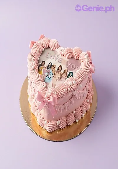 A pink heart-shaped 1-tier cake themed around Pink Vintage Photo, featuring a printed photo of girls and piped ruffles. A pink heart-shaped 1-tier cake themed around Pink Vintage Photo, featuring a printed photo of girls and piped ruffles.