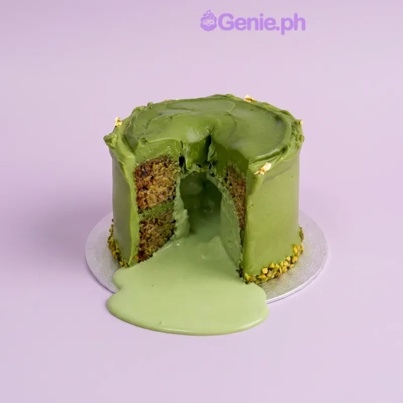 Pistachio cake with soft green icing, chopped pistachios, and gold leaf flakes Pistachio cake with soft green icing, chopped pistachios, and gold leaf flakes