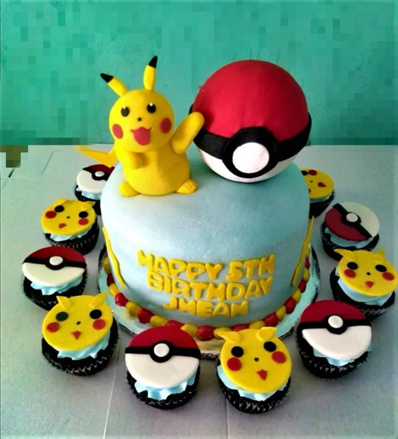 A light blue 1 Tier Fondant Pokemon Pikachu cake, featuring a Pikachu and Pokeball topper, with lightning bolts and border balls. A light blue 1 Tier Fondant Pokemon Pikachu cake, featuring a Pikachu and Pokeball topper, with lightning bolts and border balls.