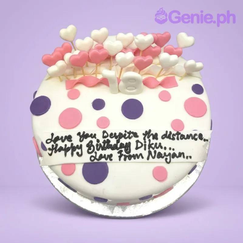 A white, pink, and purple 1 Tier Fondant cake themed around Polka Dot Heart, featuring a white '18' and heart toppers, with polka dots and a side message. A white, pink, and purple 1 Tier Fondant cake themed around Polka Dot Heart, featuring a white '18' and heart toppers, with polka dots and a side message.