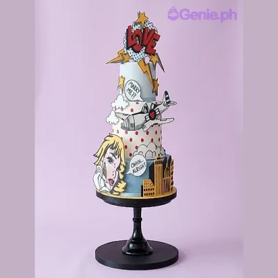 Light blue 3-tier fondant cake with pop art comic book theme featuring a plane, city skyline, and speech bubbles Light blue 3-tier fondant cake with pop art comic book theme featuring a plane, city skyline, and speech bubbles