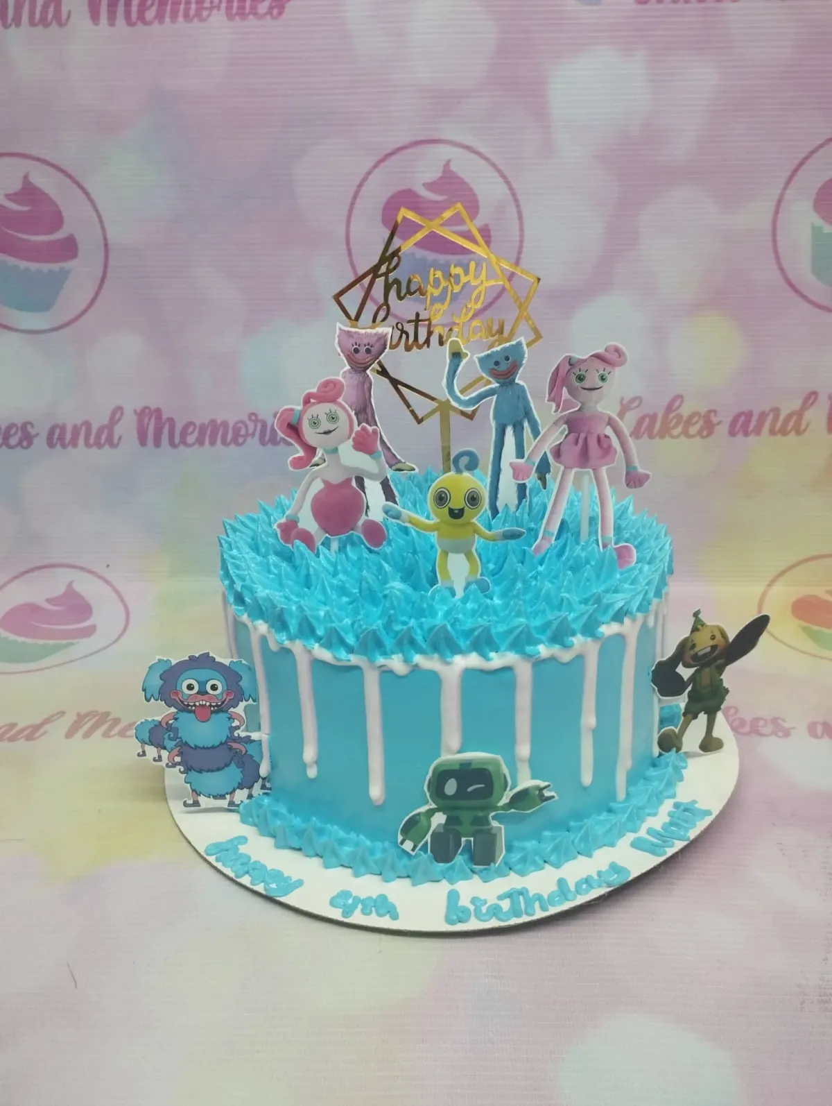 A light blue 1-tier Poppy Playtime cake, featuring character printouts, white drip, and blue rosettes. A light blue 1-tier Poppy Playtime cake, featuring character printouts, white drip, and blue rosettes.